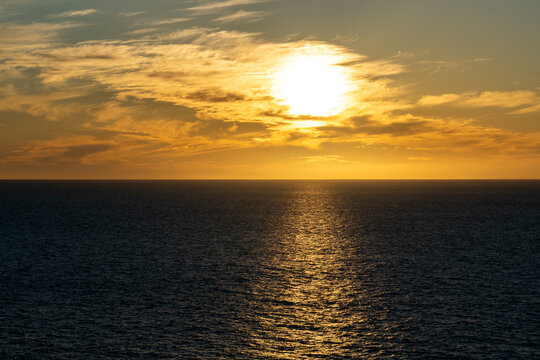 Beautiful sunset with great cloudscape over the Pacific and the reflection of the sun in the sea.