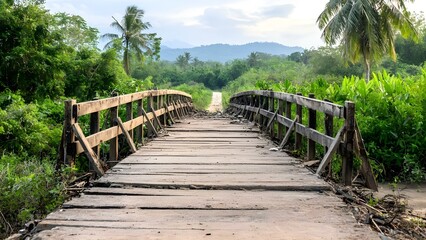 A wooden bridge spans a lush green landscape, leading into the distance with a backdrop of mountains and palm trees. Concept Wooden Bridge, Lush Green Landscape, Mountains in Background, Palm Trees