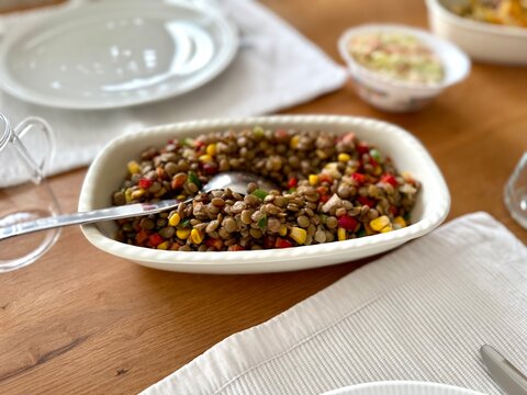 Azifa is a popular Ethiopian salad consisting of green lentils, finely chopped tomatoes, and onions close up in the plate on the table.