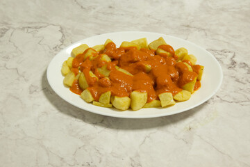A plate of food with a red sauce on top