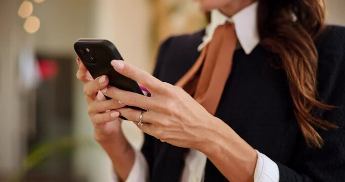 Woman, hands and typing with phone at hotel for online booking, schedule or checking reservation. Closeup, female person or concierge texting with mobile smartphone for communication at luxury resort