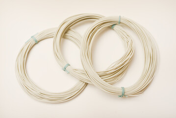 Fototapeta premium Twists of mounting wires on a white background. White wires of electronics.