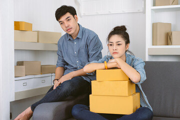 Young Asian couple freelance working at home and start up small business entrepreneur SME with...