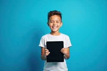 Young boy is holding tablet computer in his hands