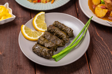 Menorah lighted candles in candlesticks with the Star of David at the set table dolma