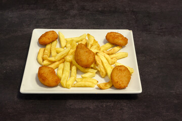 A plate of fried chicken and french fries