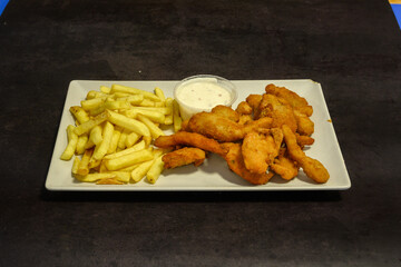 A plate of fried chicken and french fries