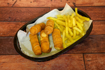 A plate of four fried doughnuts and four french fries