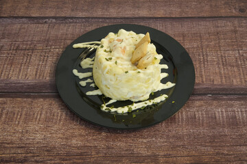 A small dish of food with a sauce on top