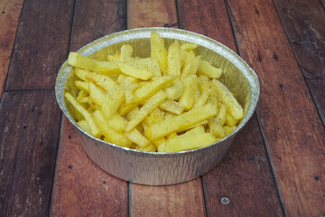 A bowl of french fries with a sprinkle of salt
