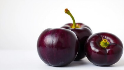 A single ripe plum, vibrant purple, sits on a pure white background, ripe, nature