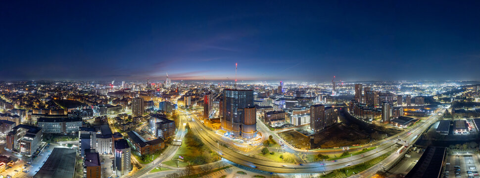 Panoramic Aerial View of Leeds City Center at Dawn with Illuminated Buildings
