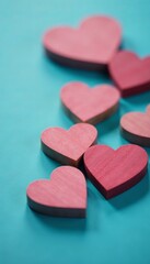 Obraz premium Close-up of little wooden hearts against blue backdrop, creativity, retro, vintage