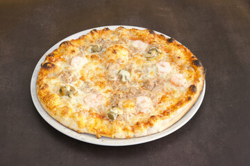 A pizza with shrimp and mushrooms on top