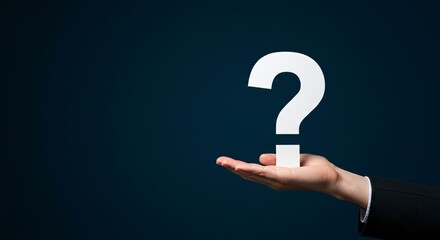 White question mark symbol on hand of caucasian man in business suit over dark blue background. Solution, ideas concepts and Frequently Asked Questions