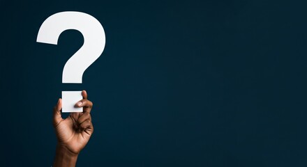 African american man holding big question mark cutout against dark blue background, seeking answers, copy space. Posing questions and searching for solutions.