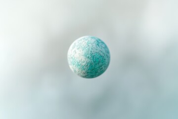 A teal sphere with a marbled texture floats in a soft, light blue background.