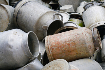Large pile of various old aluminum pots and cans, aluminum scrap background
