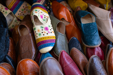 Colorful Vibrant leather handmade Moroccan slippers, babouches for sale in traditional local souk,...