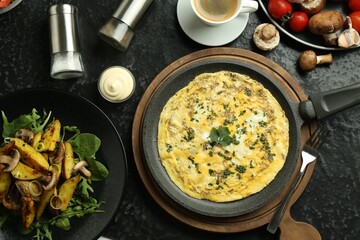 Tasty food served for brunch on black table, flat lay