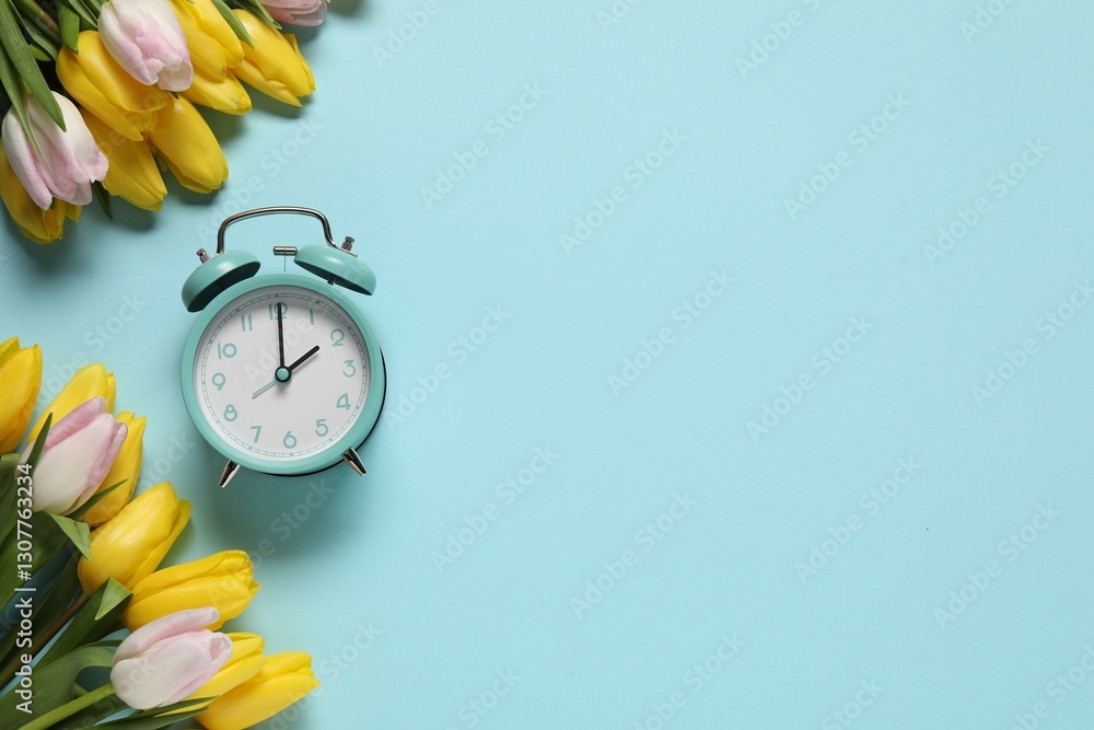 Poster spring time. alarm clock and beautiful tulips on light blue background, flat lay. space for text