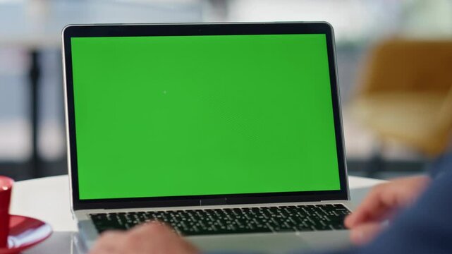 Man hands typing greenscreen laptop sitting cafeteria closeup. Manager working
