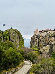 a monastery on a cliff in meteora, greece