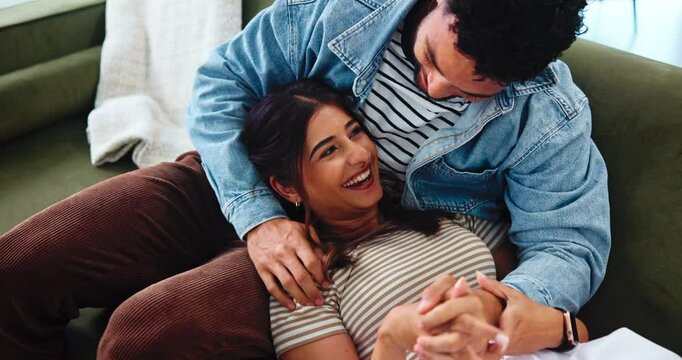 Love, happy couple and tickle on sofa, laugh or bonding together with partner to relax. Funny, woman and playful man in home for romantic game, connection and holding hands for relationship above
