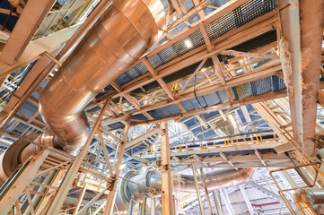Modern chemical plant showcasing intricate pipelines and conveyor systems operating in an...