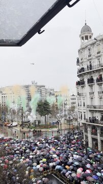 Mascleta on Las Fallas on the main square of Valencia, Spain. Colorful fireworks, traditional pyrotechnic show. Mascleta during the rain. Green and orange colors.