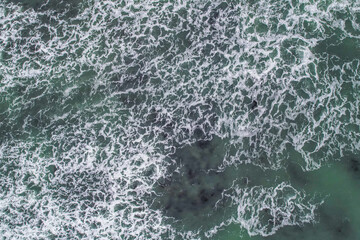 Aerial, Winter’s crashing tidal waves at Down Derry in Cornwall UK