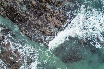 Obraz premium Aerial, Winter’s crashing tidal waves at Down Derry in Cornwall UK