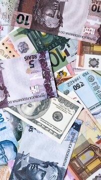 A background consisting of paper banknotes of different currencies of the USA, Europe, Brazil. Multicurrency background