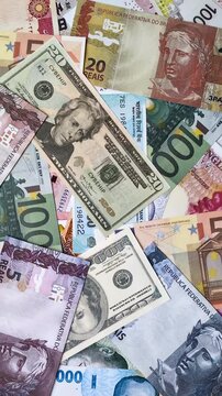 A background consisting of paper banknotes of different currencies of the USA, Europe, Brazil. Multicurrency background
