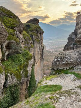 monastery on a cliff in metora, greece at sunset