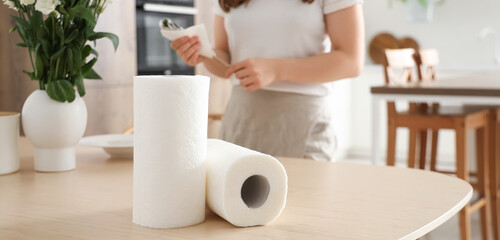 Rolls of paper towels on table in kitchen, closeup