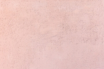 Light pink textured wall surface with subtle patterns
