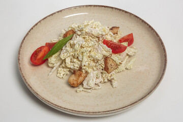 The image shows a salad dish served on a beige plate. 