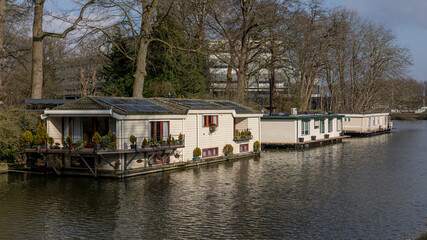 Floating houseboats on a canal in the Hanseatic city of Zwolle in Overijssel, a typical image of...