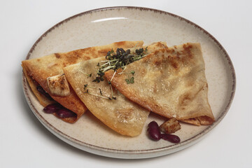 The image shows a plate with three quesadillas. 