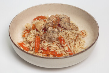 The image shows a bowl of rice dish with chicken and vegetables