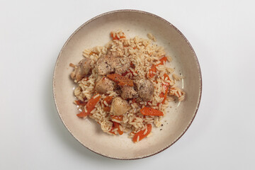 The image shows a bowl of rice dish with chicken and vegetables
