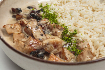 The image shows a bowl containing a savory dish. 