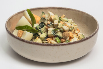 The salad is served in a light-colored, rustic-style bowl with a darker brown rim, giving it an earthy, homemade appearance. 