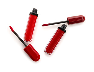 Modern red lipsticks with brushes on white background