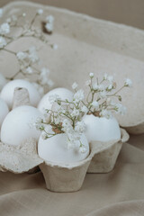 White Eggs with Babe Wreath Flowers in Open Carton.Natural healthy food and organic farming concept