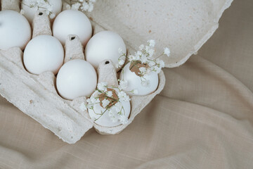 White Eggs with Babe Wreath Flowers in Open Carton.Natural healthy food and organic farming concept