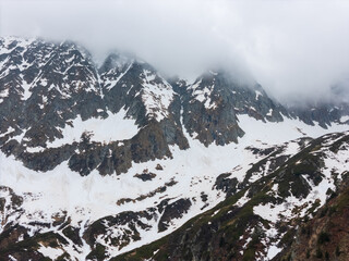 early spring in the mountains, the last snow is melting in the valley
