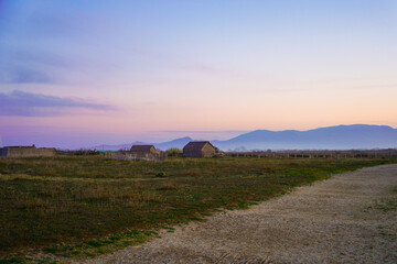 Historic fishing village with old reed log cabins during sunset on a pond 