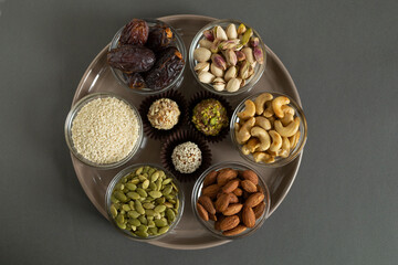 Handmade energy balls with nuts, dried fruits. healthy sweet snack, candy free sugar. raw dessert made from dates, apricot, almond, cashew, pistachio, sesame seed. Vegetarian organic food with